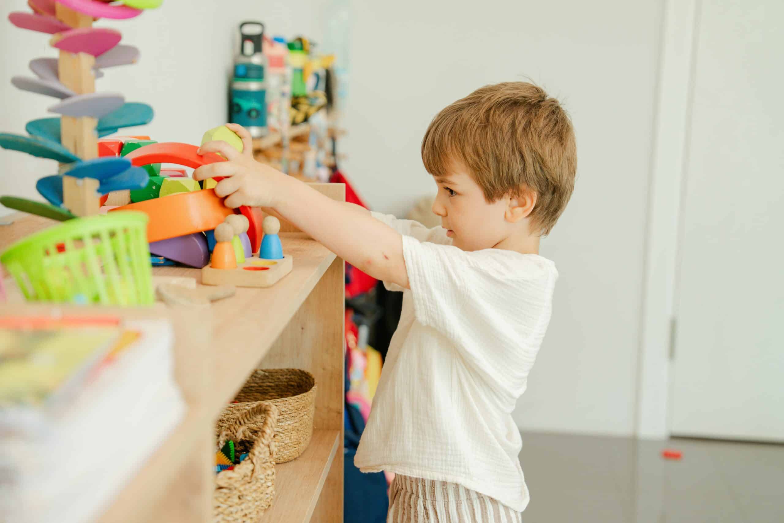 Child exploring toys on shelves