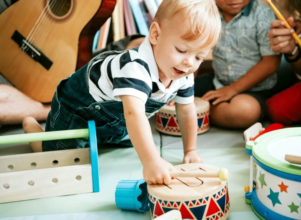 Child playing with a drum