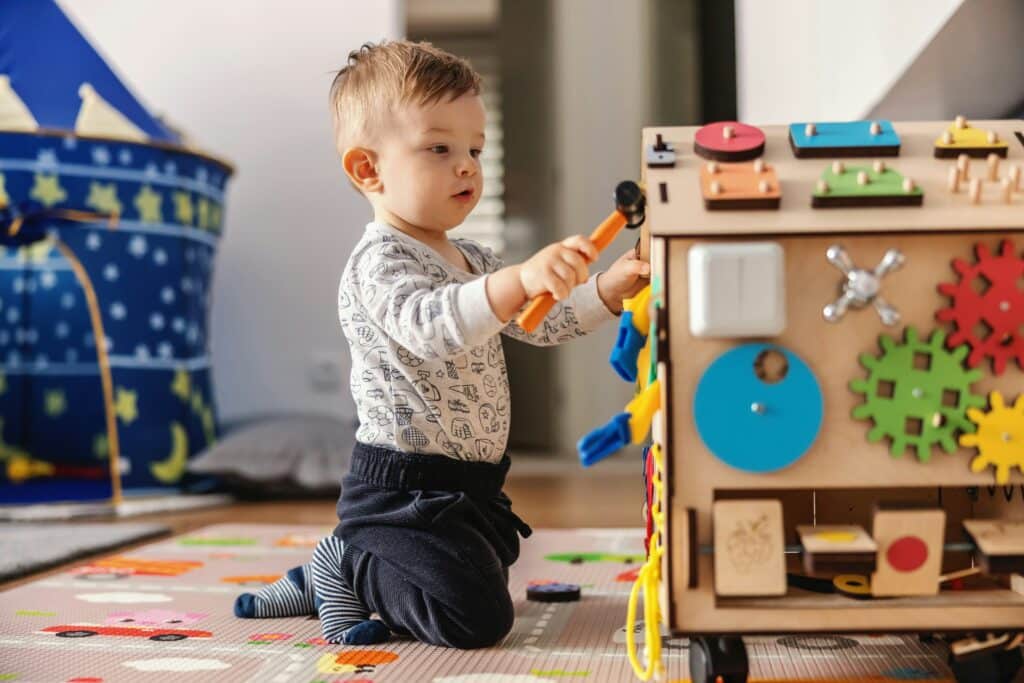 Child playing with a busy board