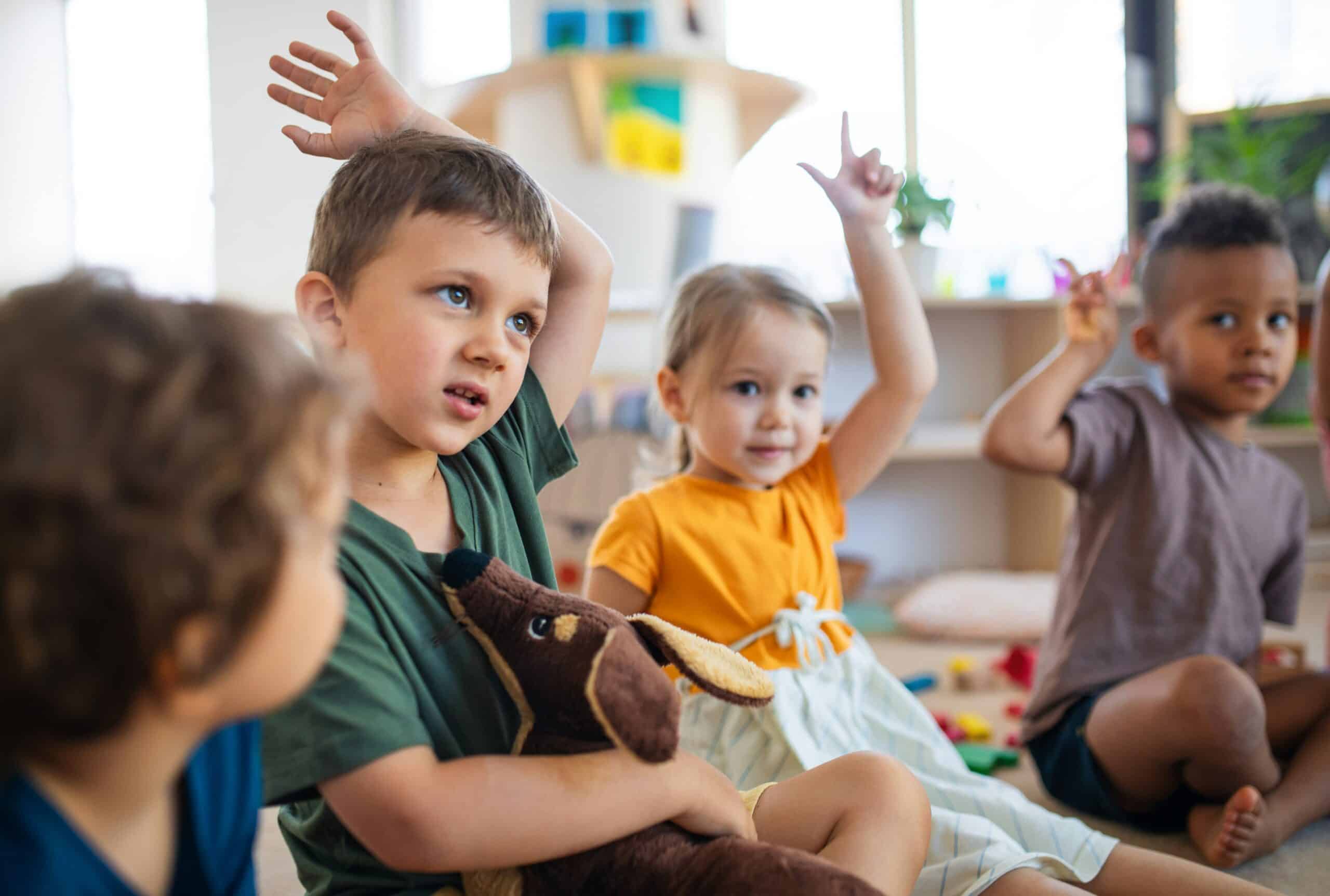 Children raising hands in a group activity