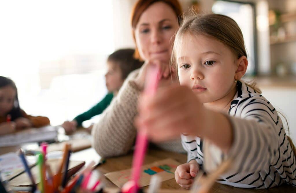 Educator helping child with activity