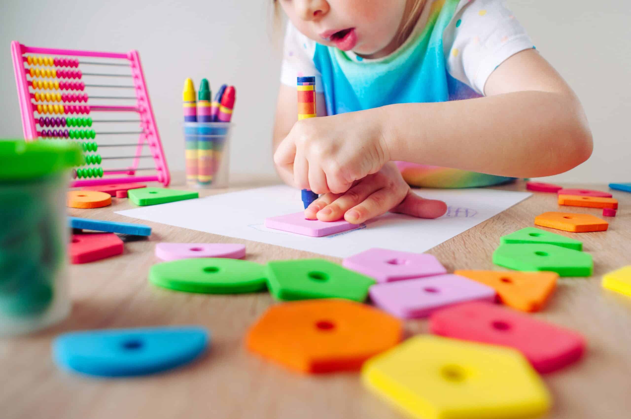 Child drawing with crayons