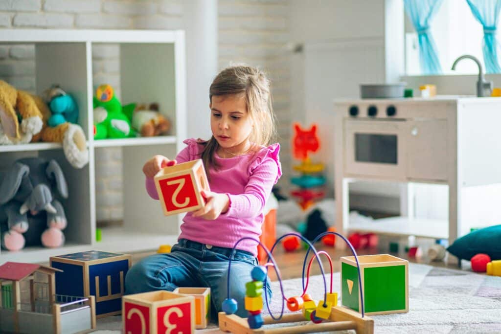 Child playing with large blocks