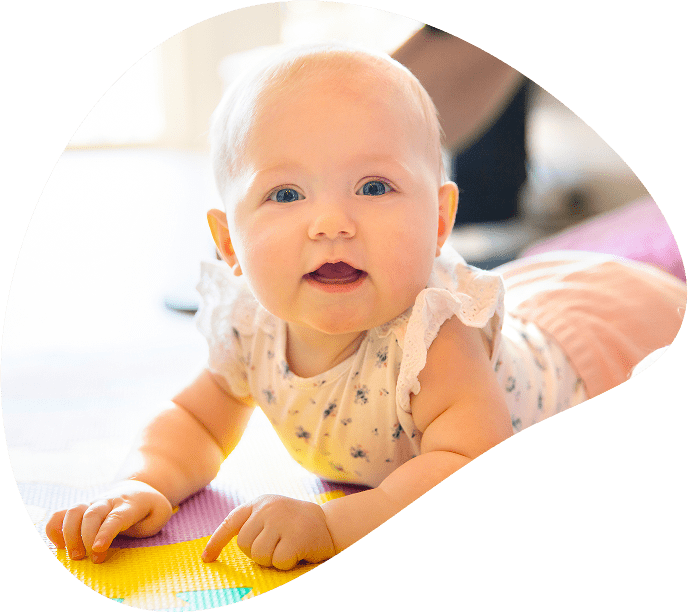 Happy baby on play mat